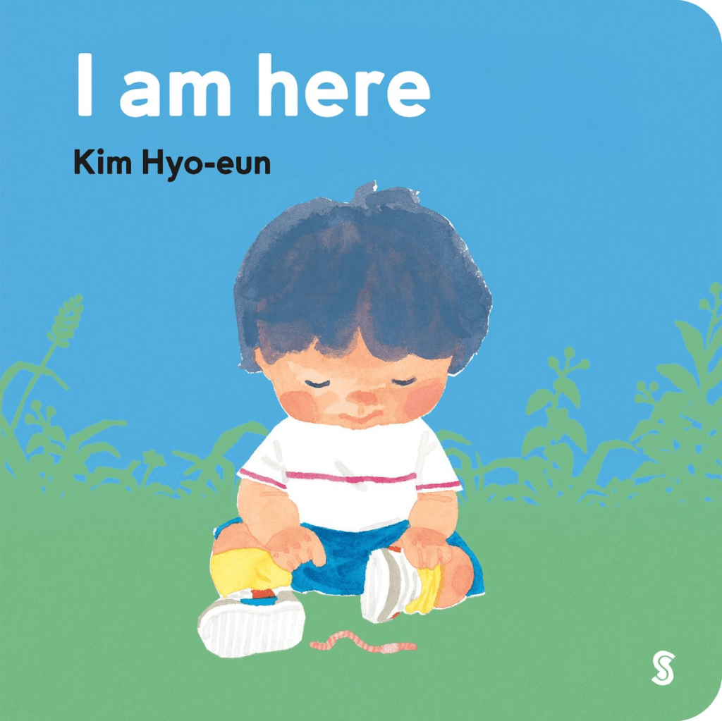 Cover image for I Am Here by Kim Hyo-eun, translated by Aerin Park, featuring a child seating in the grass under a blue sky looking at a worm.
