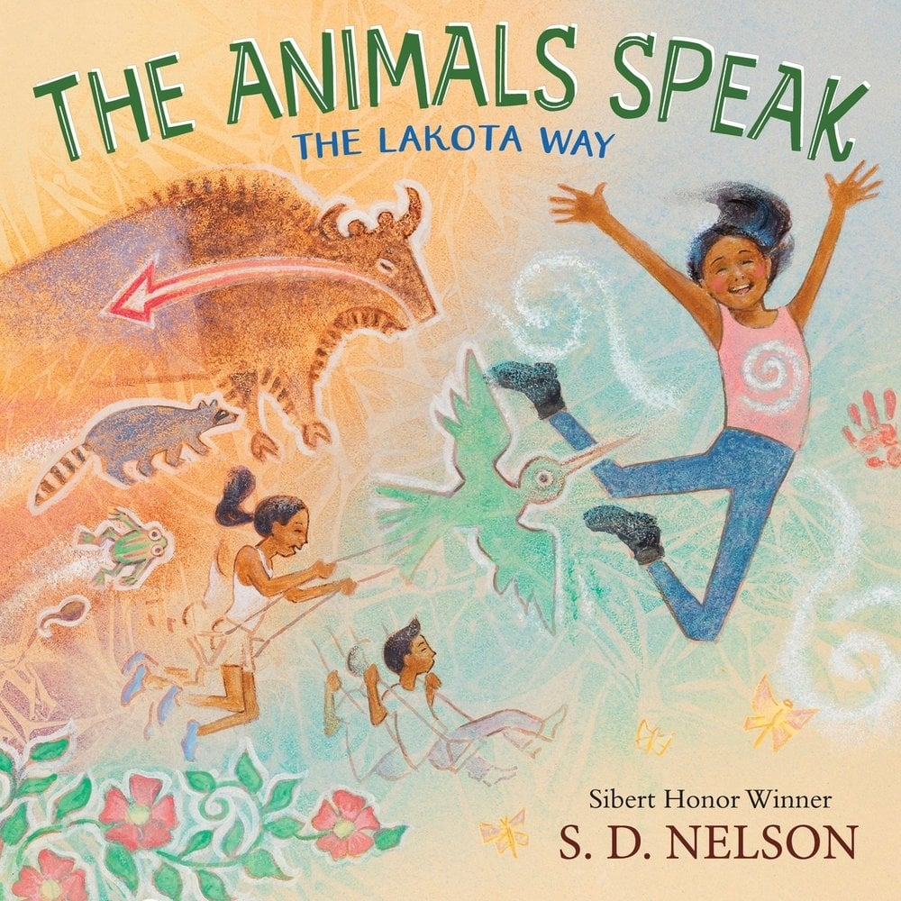 Cover image for The Animals Speak: The Lakota Way by S. D. Nelson, featuring a girl jumping on the page followed by butterflies, flowers, a bison, raccoon, frog, tadpole and bird as well as other children on swings.
