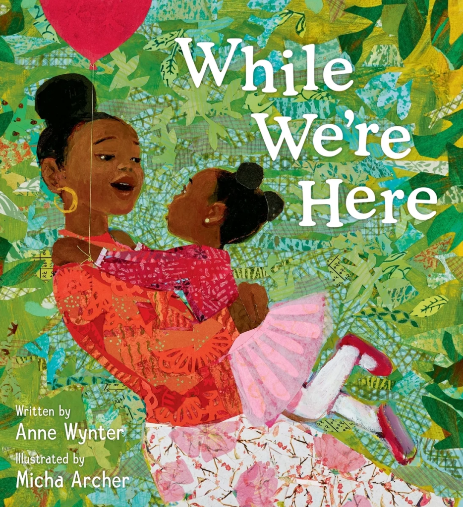 Cover image for While We’re Here by Anne Wynter, illustrated by Micha Archer, featuring a Black mother and daughter hugging one another with a red balloon tied to the little girl's wrist.